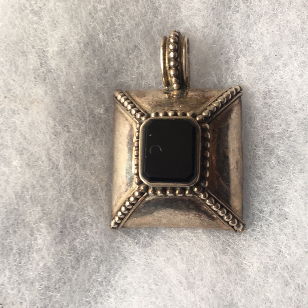 Silver pendant with black center stone